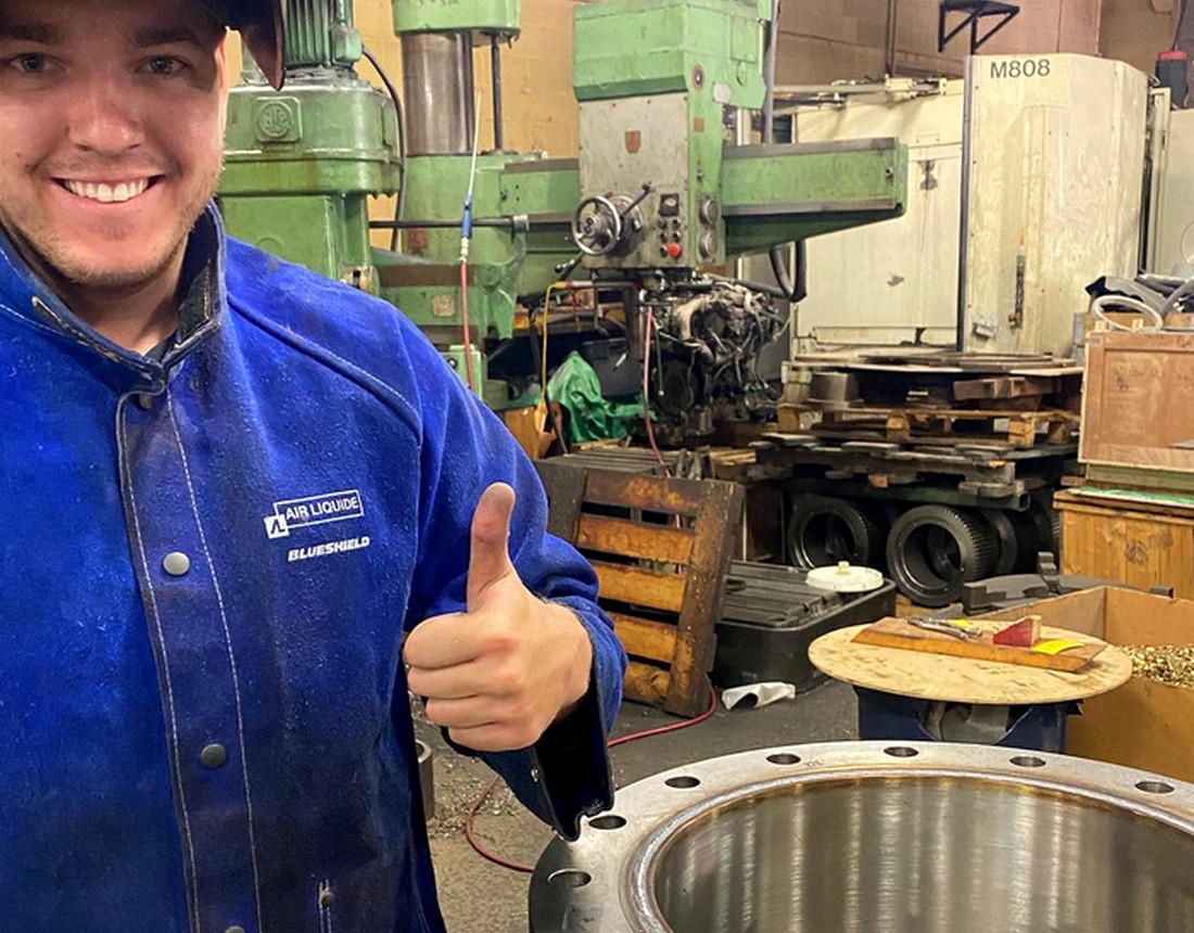 Welcan team member with large machined part